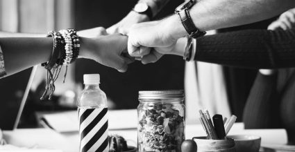 5 people fist bumping