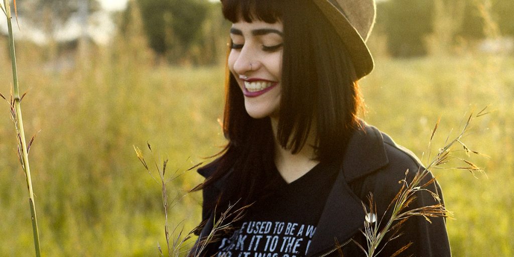 A person walking through a feild in the sun